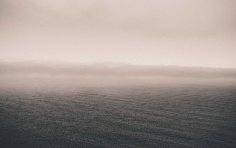 Calm misty ocean horizon at dawn, placeholder hero image