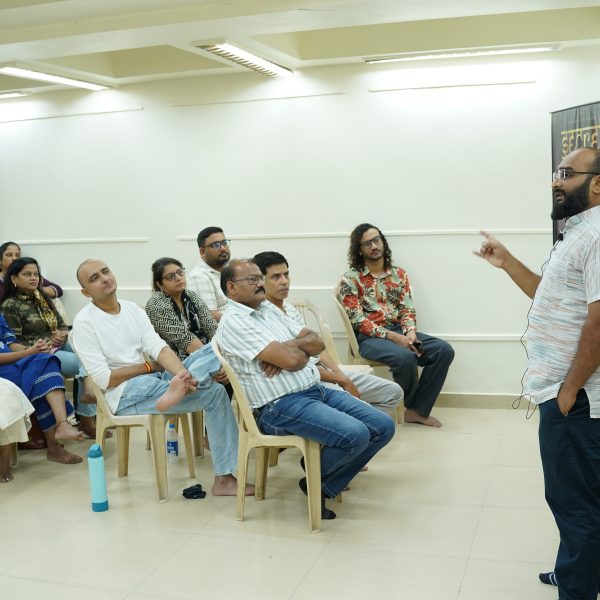 A practitioner leading a workshop session with a seated group