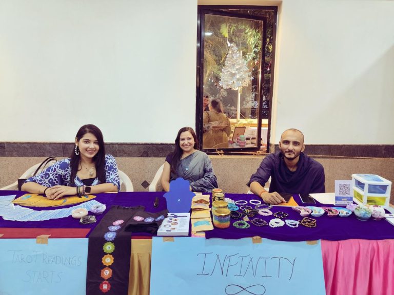 Practitioners at an Infiniti Soul stall offering tarot readings and crystal bracelets