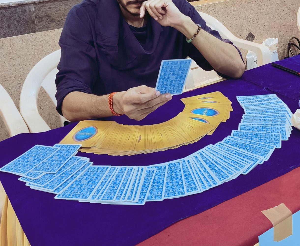 A tarot card reading in progress, cards fanned out on a table