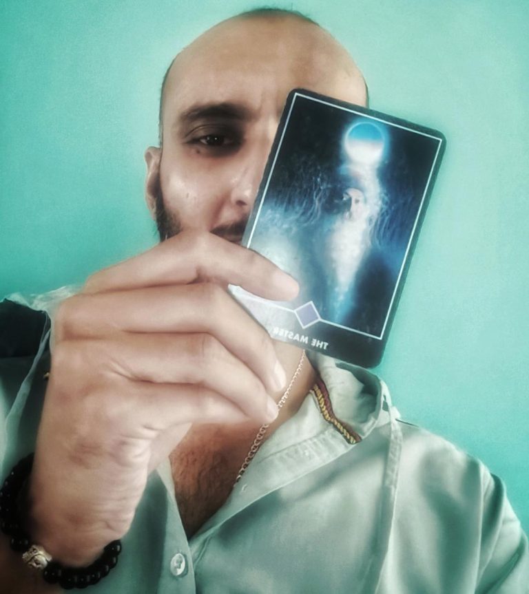 Tarot card portrait, a practitioner holding a card to the face in reflection