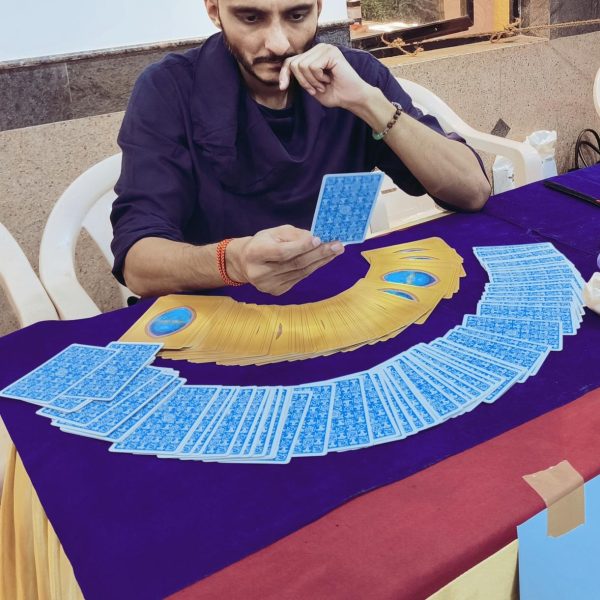 A tarot card reading in progress, cards fanned out on a table