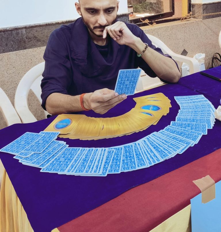 A tarot card reading in progress, cards fanned out on a table