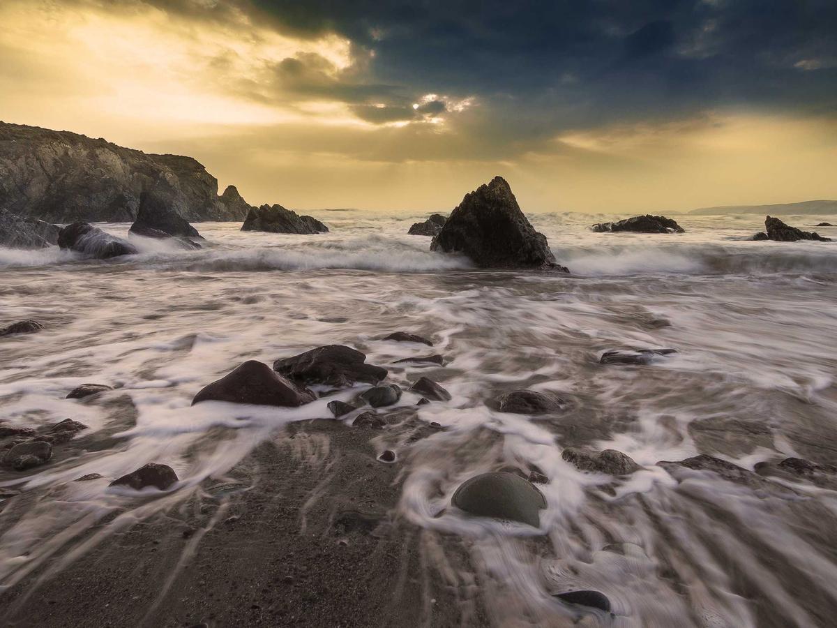 Dramatic rock formations along a coastline at dusk